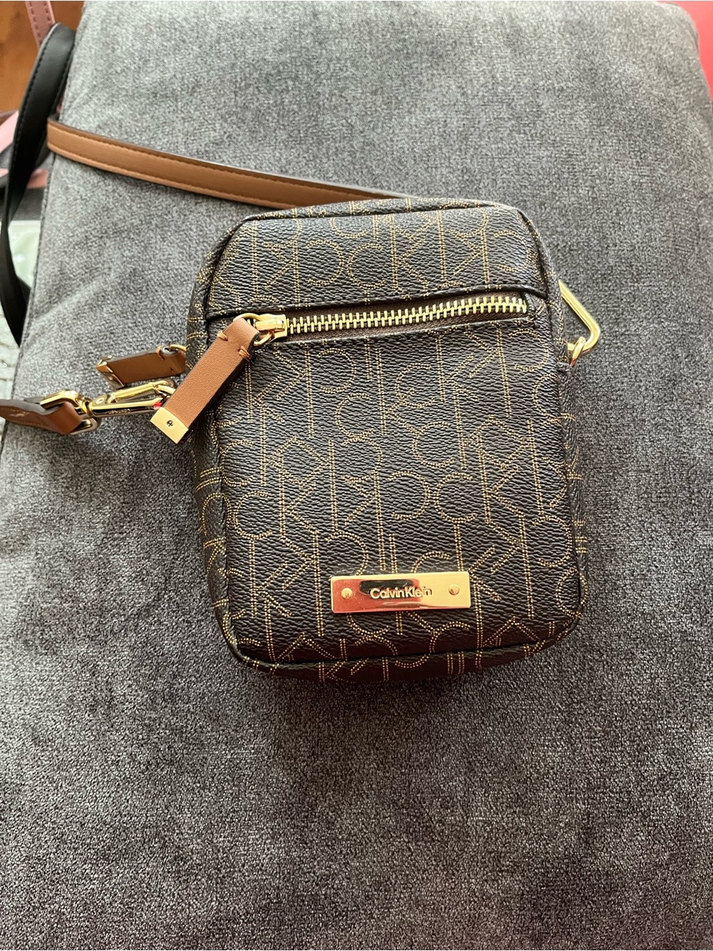 Calvin Klein Brown Monogram mini Crossbody bag with gold hardware.